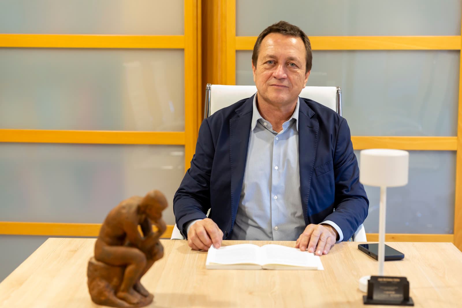 Juan Bertomeu reading at his desk in the Expat Abogados office
